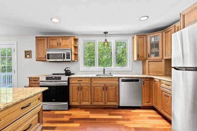 59 First Parish Rd, Norwell, MA 02061 - kitchen featuring stainless steel appliances, light wood-style flooring, light stone counters, recessed lighting, and hanging light fixtures