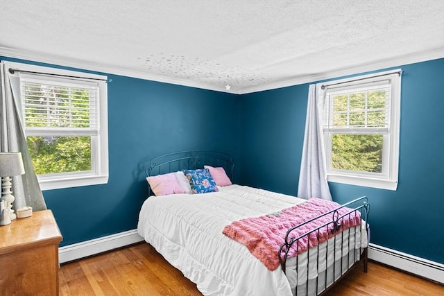 59 First Parish Rd, Norwell, MA 02061 - bedroom featuring a baseboard heating unit, a textured ceiling, wood finished floors, and crown molding