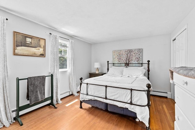 59 First Parish Rd, Norwell, MA 02061 - bedroom with light wood-style flooring and a baseboard heating unit