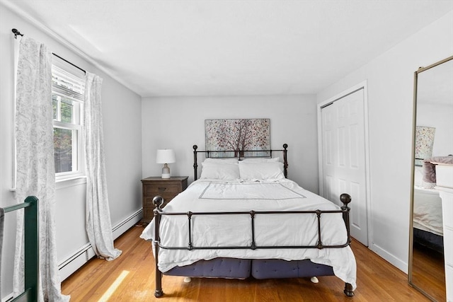 59 First Parish Rd, Norwell, MA 02061 - bedroom with a baseboard radiator, light wood-style floors, and a closet