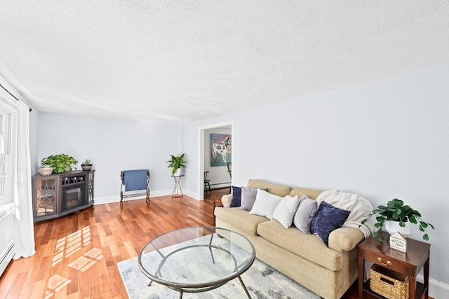 59 First Parish Rd, Norwell, MA 02061 - living room featuring a textured ceiling and light wood finished floors