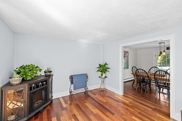 59 First Parish Rd, Norwell, MA 02061 - sitting room featuring wood finished floors and a baseboard heating unit