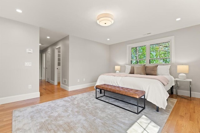 bedroom featuring light wood-type flooring, baseboards, and recessed lighting