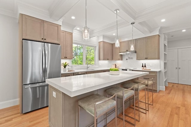 kitchen featuring stainless steel fridge, light wood finished floors, beam ceiling, backsplash, and ornamental molding