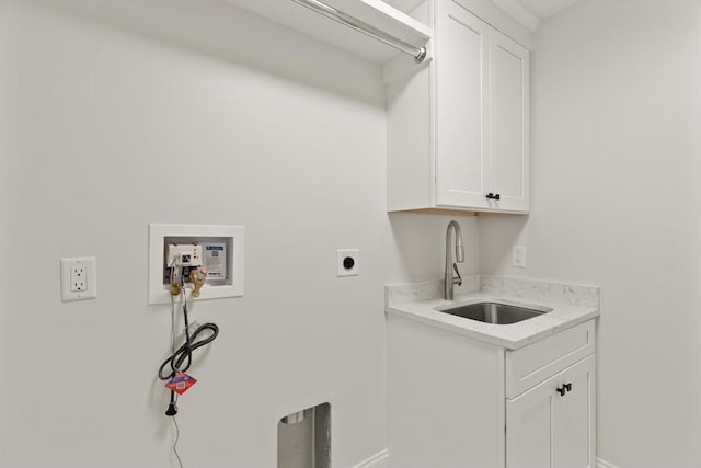 washroom featuring hookup for an electric dryer, baseboards, cabinet space, and hookup for a washing machine