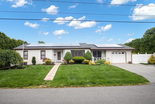 136 Maryland Ave, Somerset, MA 02726 - single story home with an attached garage, solar panels, driveway, and brick siding