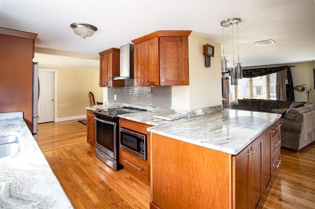 136 Maryland Ave, Somerset, MA 02726 - kitchen featuring wall chimney range hood, stainless steel appliances, open floor plan, and light wood-type flooring