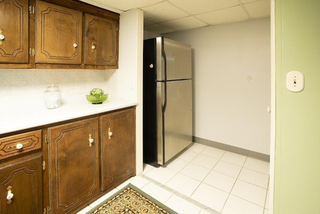136 Maryland Ave, Somerset, MA 02726 - kitchen with freestanding refrigerator, light countertops, baseboards, and light tile patterned floors