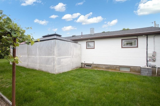 136 Maryland Ave, Somerset, MA 02726 - rear view of house with central AC and a lawn