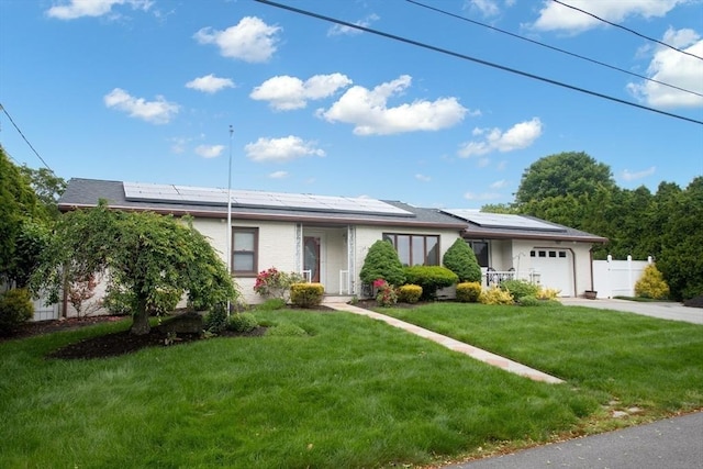 136 Maryland Ave, Somerset, MA 02726 - ranch-style house with a garage, driveway, and roof mounted solar panels