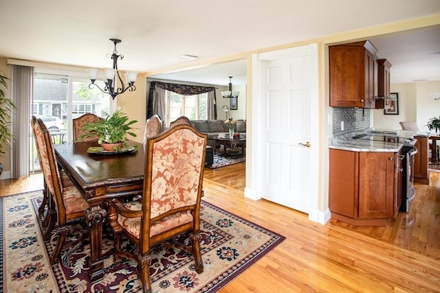 136 Maryland Ave, Somerset, MA 02726 - dining space with a chandelier and light wood-style flooring