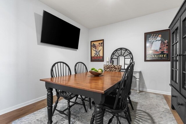 dining room featuring baseboards and wood finished floors