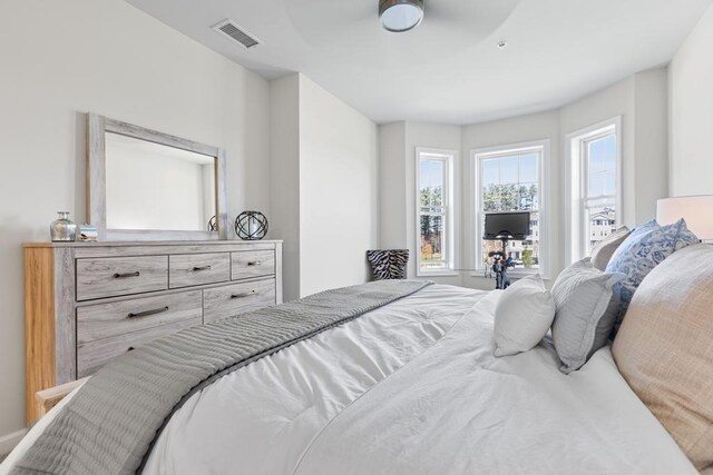 bedroom with ceiling fan and visible vents