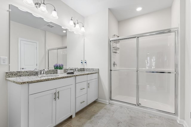 bathroom with double vanity, baseboards, recessed lighting, a sink, and a stall shower