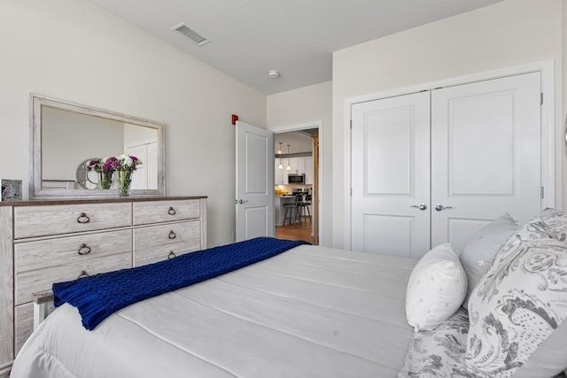 bedroom with visible vents and a closet