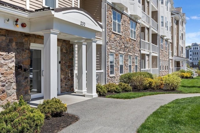 doorway to property with stone siding