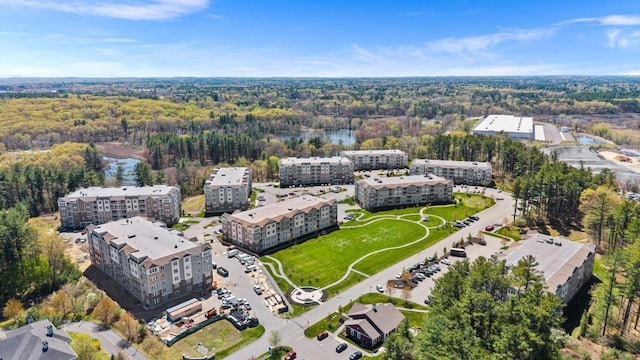 bird's eye view with a wooded view