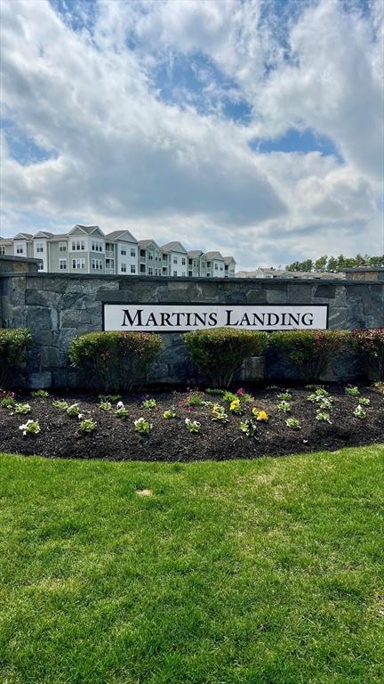 community / neighborhood sign featuring a yard and a residential view