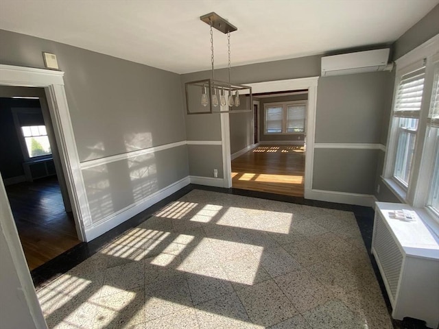 135-137 Summer St, Waltham, MA 02452 - unfurnished dining area with an AC wall unit and baseboards
