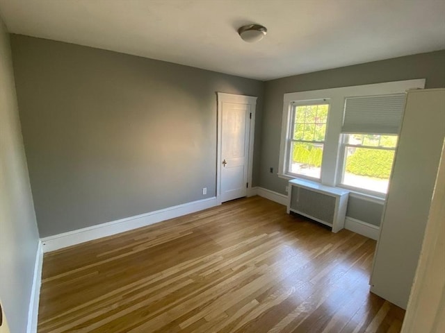 135-137 Summer St, Waltham, MA 02452 - empty room featuring radiator, baseboards, and wood finished floors