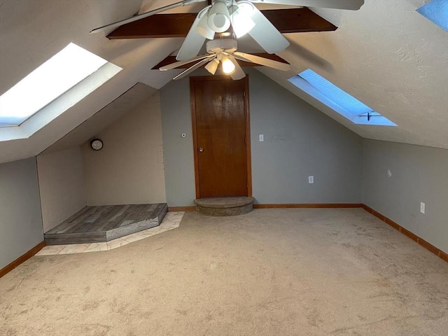 135-137 Summer St, Waltham, MA 02452 - additional living space with a skylight, carpet, vaulted ceiling, baseboards, and ceiling fan