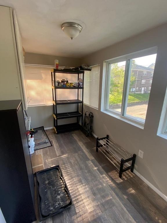 135-137 Summer St, Waltham, MA 02452 - unfurnished bedroom featuring dark wood-style floors and baseboards