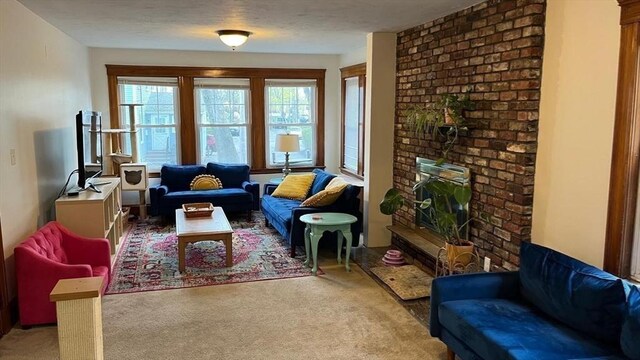 135-137 Summer St, Waltham, MA 02452 - living room with light carpet and a fireplace