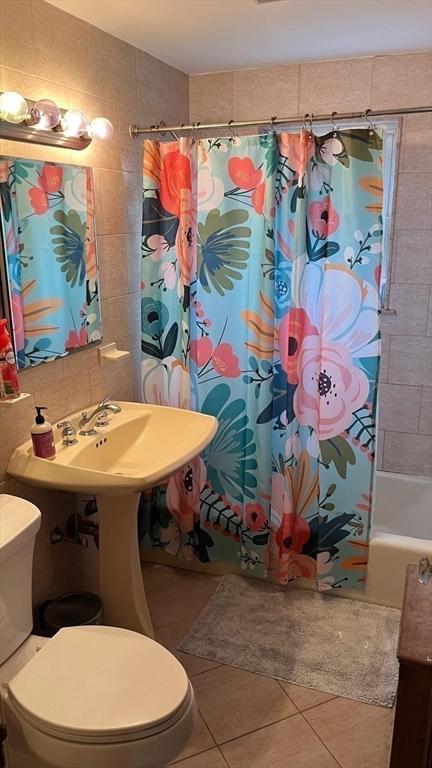 135-137 Summer St, Waltham, MA 02452 - full bathroom with tile patterned floors, toilet, tile walls, and shower / bathtub combination with curtain
