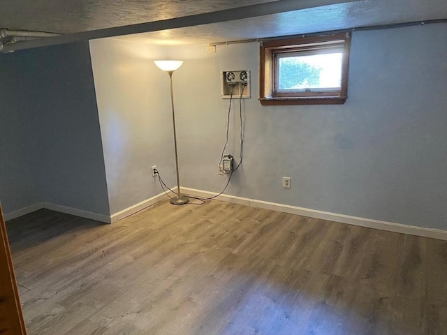 135-137 Summer St, Waltham, MA 02452 - below grade area featuring wood finished floors and baseboards