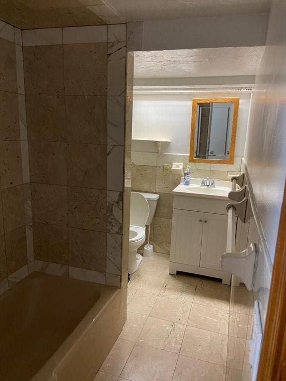 135-137 Summer St, Waltham, MA 02452 - full bathroom with toilet, vanity, and tile walls