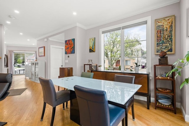 dining space with crown molding, light wood-type flooring, recessed lighting, and baseboards