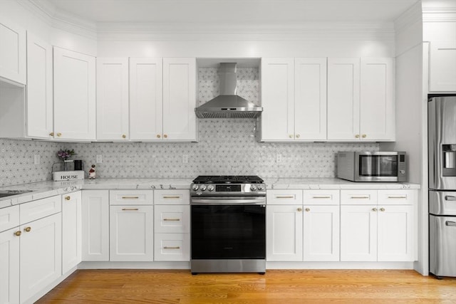 kitchen featuring wall chimney exhaust hood, stainless steel appliances, white cabinets, and light wood finished floors