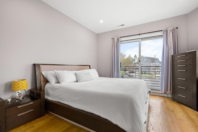 bedroom featuring light wood-style floors, vaulted ceiling, and recessed lighting