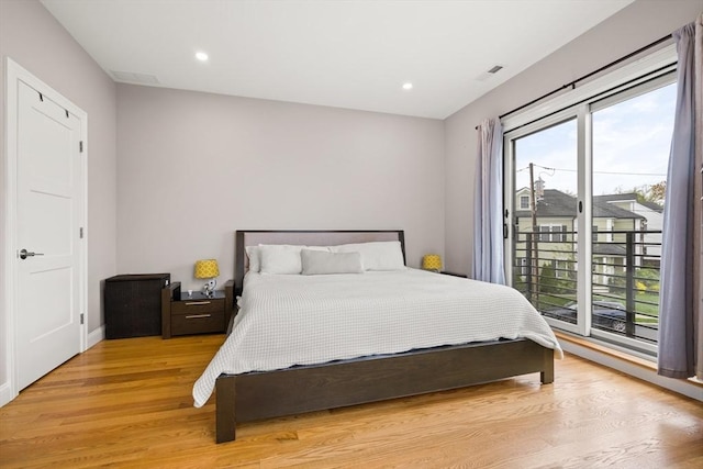 bedroom featuring light wood-style floors, access to outside, recessed lighting, and baseboards