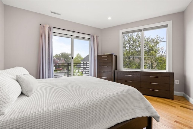 bedroom featuring light wood-type flooring, recessed lighting, and baseboards