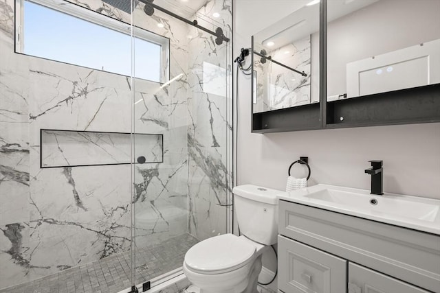 full bathroom featuring a marble finish shower, toilet, and vanity
