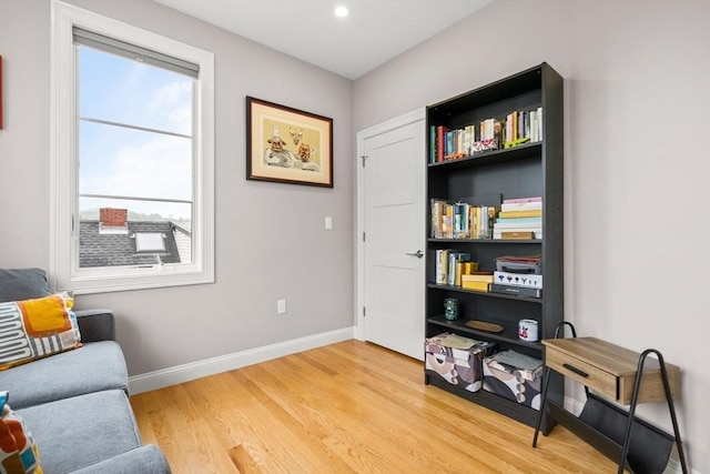 sitting room featuring baseboards, light wood-style flooring, and recessed lighting