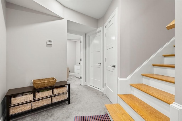 corridor with light carpet and stairway
