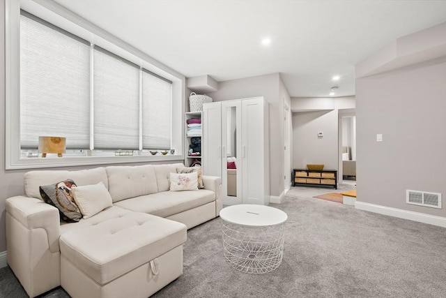living area featuring carpet, baseboards, and recessed lighting