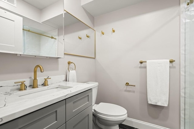 full bath featuring toilet, a shower, and vanity