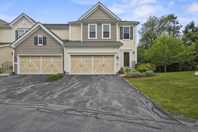 57 Kendall Ct Unit 19, Bedford, MA 01730 - view of front of home with a garage, asphalt driveway, and a front lawn