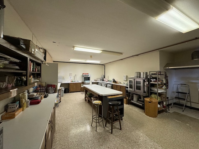 interior space featuring a kitchen island and a kitchen breakfast bar