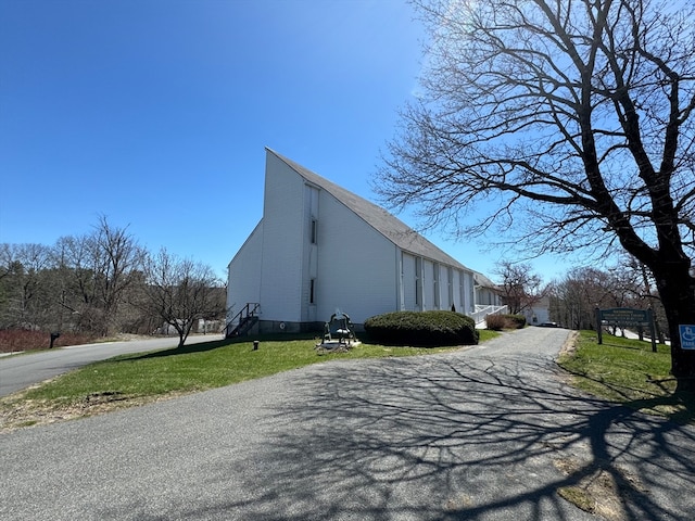 view of side of home featuring a lawn