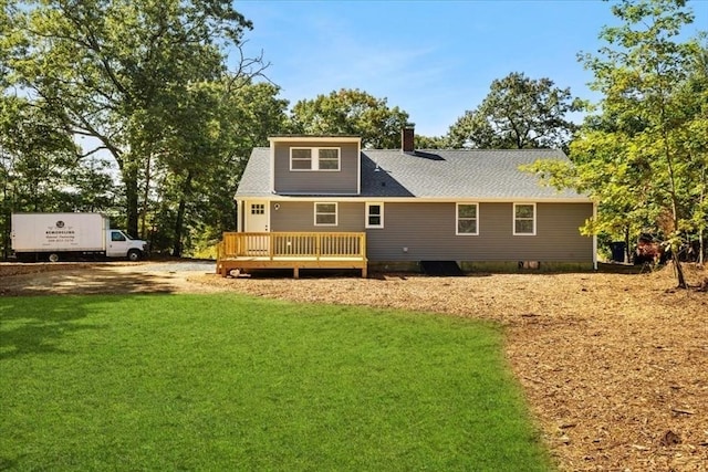 back of house with a deck and a lawn