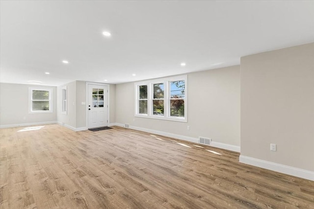 unfurnished living room with light wood-type flooring