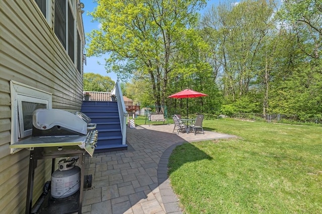 view of patio featuring a grill and stairs