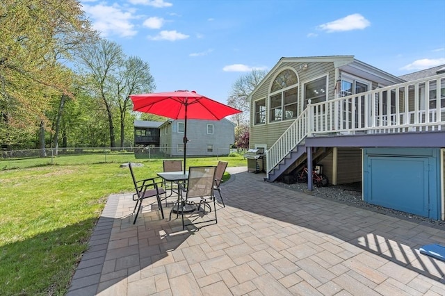 view of patio / terrace featuring stairway, grilling area, outdoor dining area, a deck, and a sunroom