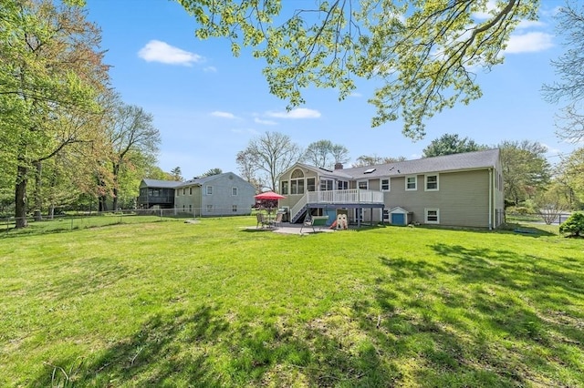 back of house featuring a patio, a chimney, stairs, and a deck
