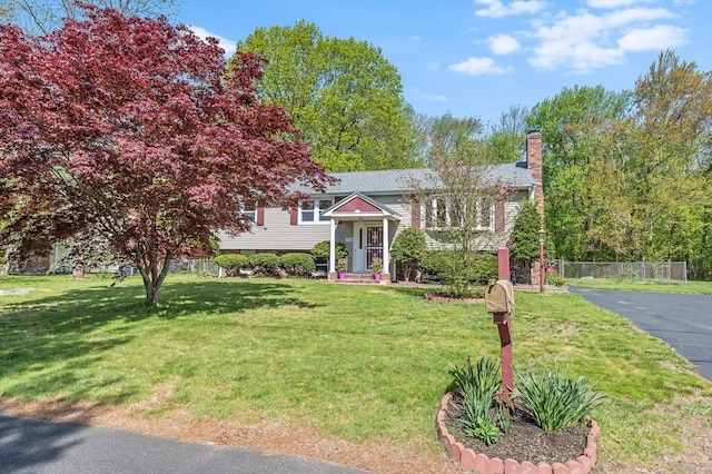 raised ranch featuring a chimney