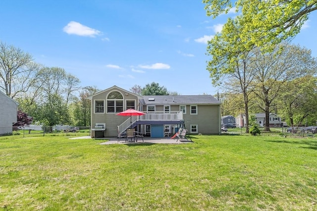 rear view of house with a patio area, stairs, and a deck